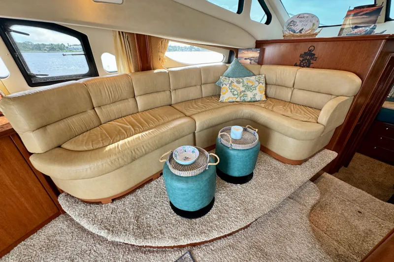  Yacht Photos Pics Luxurious interior of 2006 Silverton 38 Sport Bridge with beige leather seating and decorative pillows.