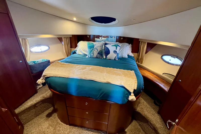  Yacht Photos Pics Luxurious bedroom interior of 2006 Silverton 38 Sport Bridge yacht with cozy bedding.