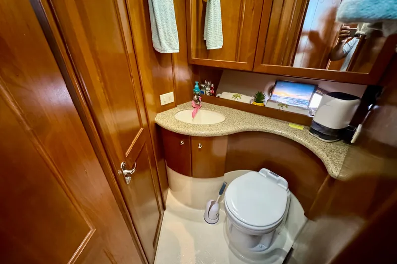  Yacht Photos Pics Luxurious bathroom in 2006 Silverton 38 Sport Bridge yacht with wooden cabinetry and modern amenities.