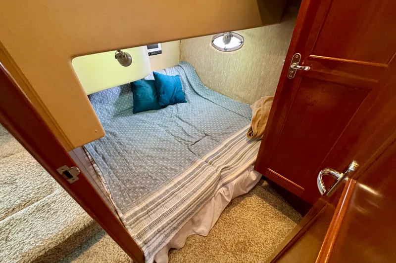  Yacht Photos Pics Cozy cabin interior of 2006 Silverton 38 Sport Bridge with bed and pillows.