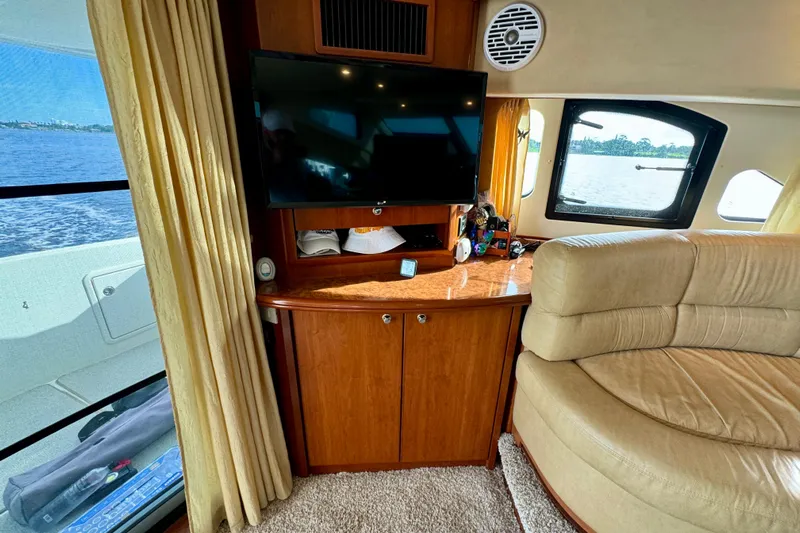  Yacht Photos Pics Interior of 2006 Silverton 38 Sport Bridge with TV, sofa, and window view.
