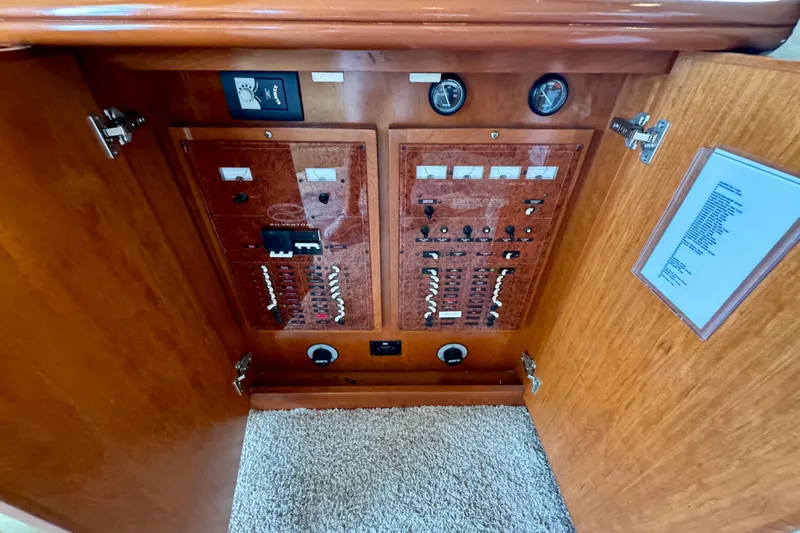  Yacht Photos Pics Electrical panel inside a 2006 Silverton 38 Sport Bridge yacht, featuring wood finish and gauges.