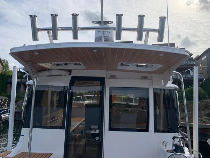  Yacht Photos Pics 2018 Cutwater C-302 Coupe boat, rear view with fishing rod holders.