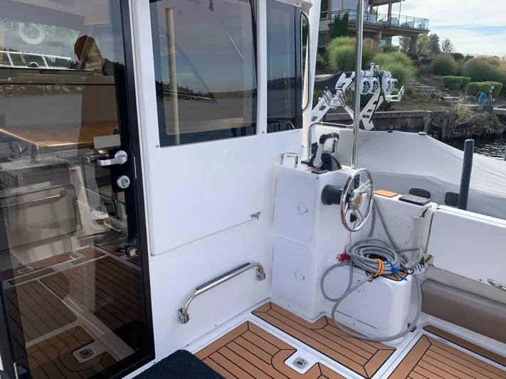  Yacht Photos Pics 2018 Cutwater C-302 Coupe boat cockpit with steering wheel and teak flooring.