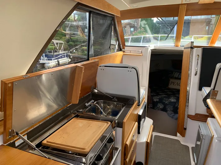 Yacht Photos Pics Interior of 2018 Cutwater C-302 Coupe boat with kitchen and seating area.