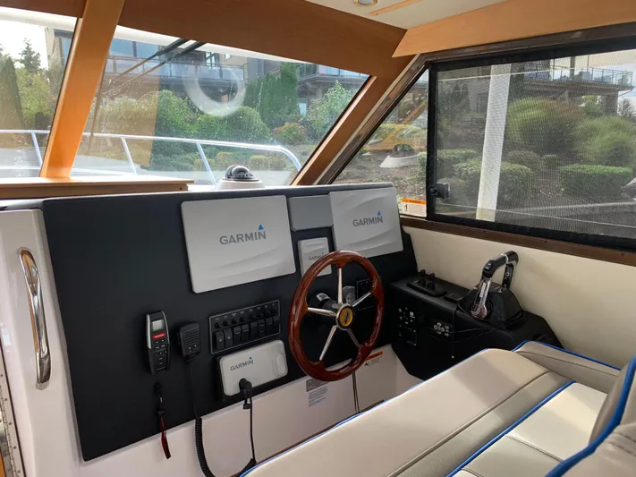  Yacht Photos Pics 2018 Cutwater C-302 Coupe helm with Garmin navigation system and leather seating.