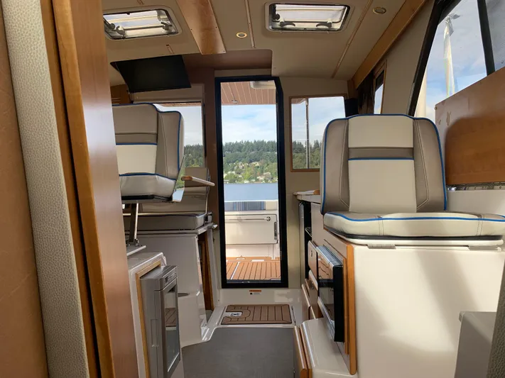 Yacht Photos Pics Interior of 2018 Cutwater C-302 Coupe boat, featuring modern seating and scenic view.