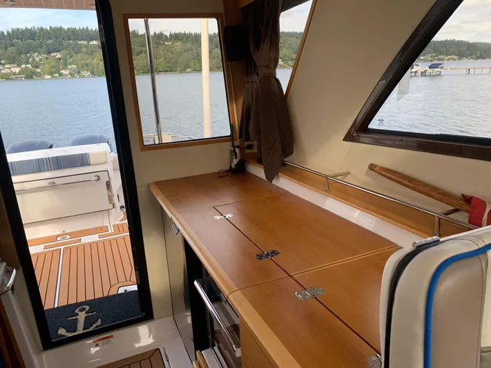  Yacht Photos Pics Interior view of 2018 Cutwater C-302 Coupe with wooden countertop and lake view.