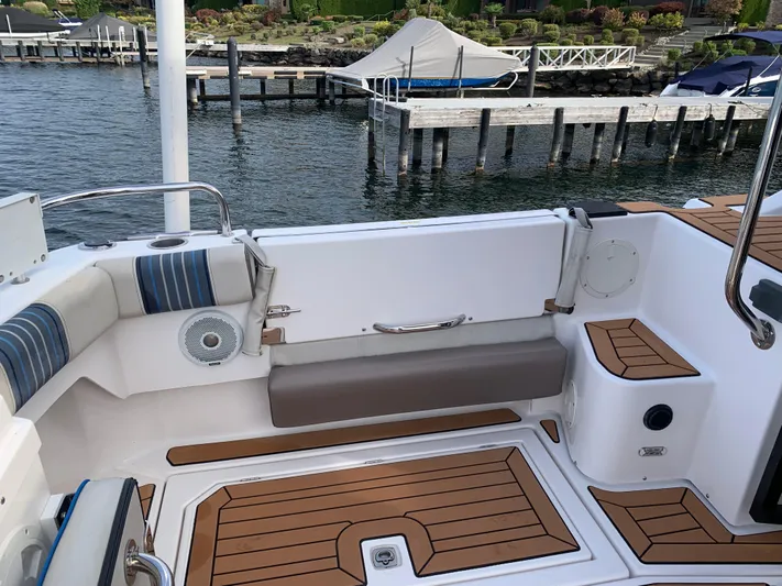  Yacht Photos Pics 2018 Cutwater C-302 Coupe boat interior with wood accents and dock view.