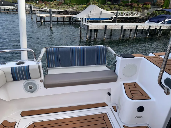  Yacht Photos Pics 2018 Cutwater C-302 Coupe boat interior with striped seating and wood accents.