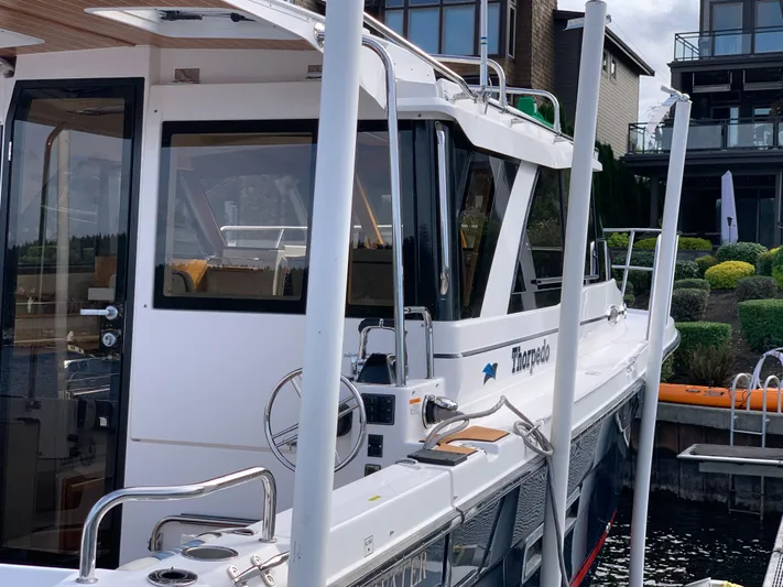  Yacht Photos Pics 2018 Cutwater C-302 Coupe docked near modern waterfront homes.