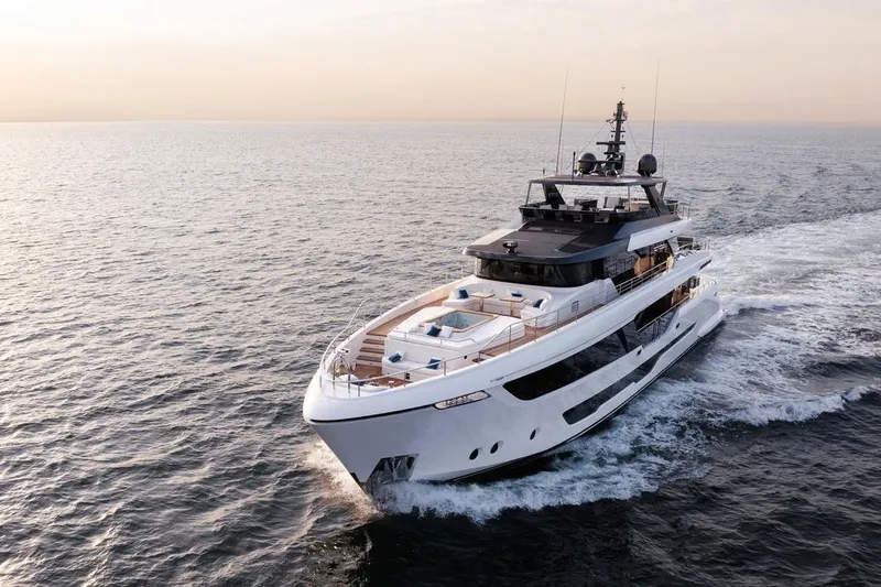  Yacht Photos Pics Luxurious 2027 Majesty 112 Terrace yacht cruising on open sea at sunset.