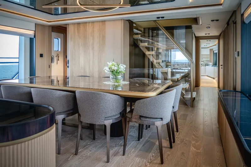  Yacht Photos Pics Luxurious interior of 2027 Majesty 112 Terrace yacht with elegant dining area and modern staircase.