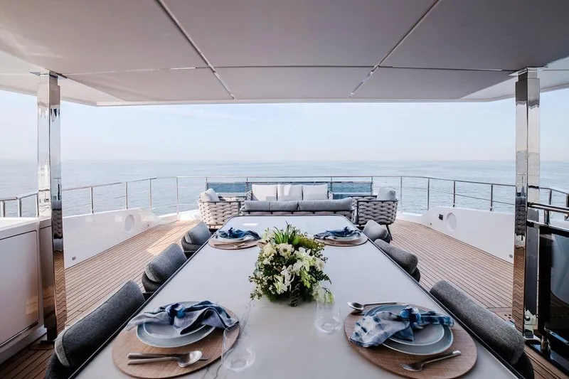  Yacht Photos Pics Luxurious dining area on 2027 Majesty 112 Terrace yacht with ocean view.