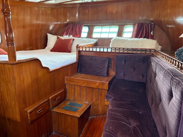 Violetta Yacht Photos Pics Interior of 1975 Formosa 51 yacht with wooden furnishings and cozy seating area.