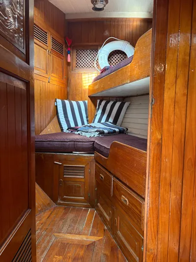 Violetta Yacht Photos Pics 1975 Formosa 51 yacht interior with wooden paneling and cozy bunk beds.