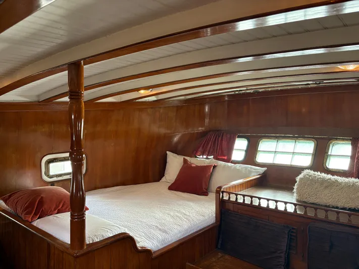 Violetta Yacht Photos Pics Luxurious wooden cabin interior of 1975 Formosa 51 yacht with cozy bed and windows.