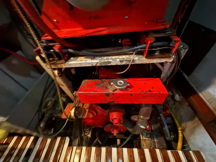 Violetta Yacht Photos Pics Engine compartment of a 1975 Formosa FORMOSA 51 sailboat, featuring a red-painted engine.