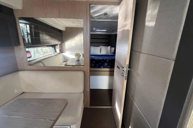  Yacht Photos Pics Interior of 2018 Azimut Atlantis 43 yacht, featuring a cozy cabin and seating area.