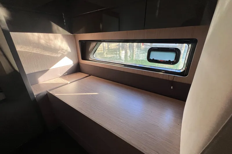  Yacht Photos Pics Interior of 2018 Azimut Atlantis 43 yacht, featuring a sleek wooden desk and window.