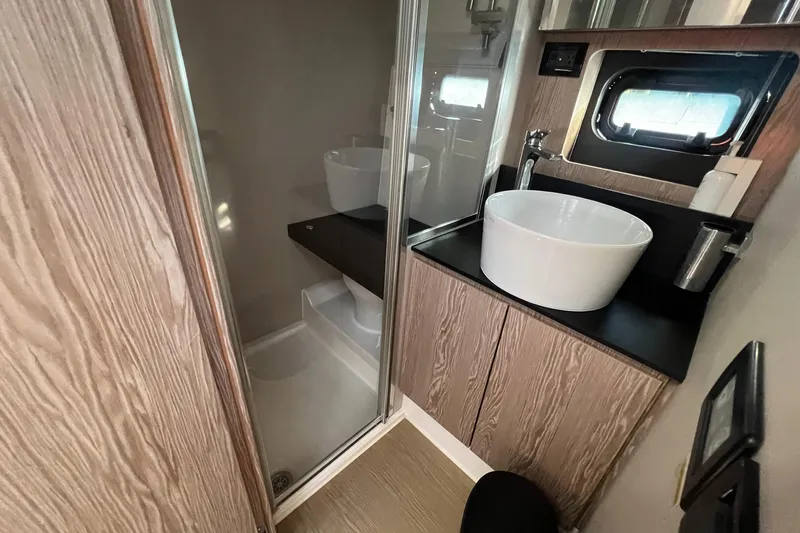  Yacht Photos Pics Luxurious bathroom in 2018 Azimut Atlantis 43 yacht with modern fixtures and wood accents.