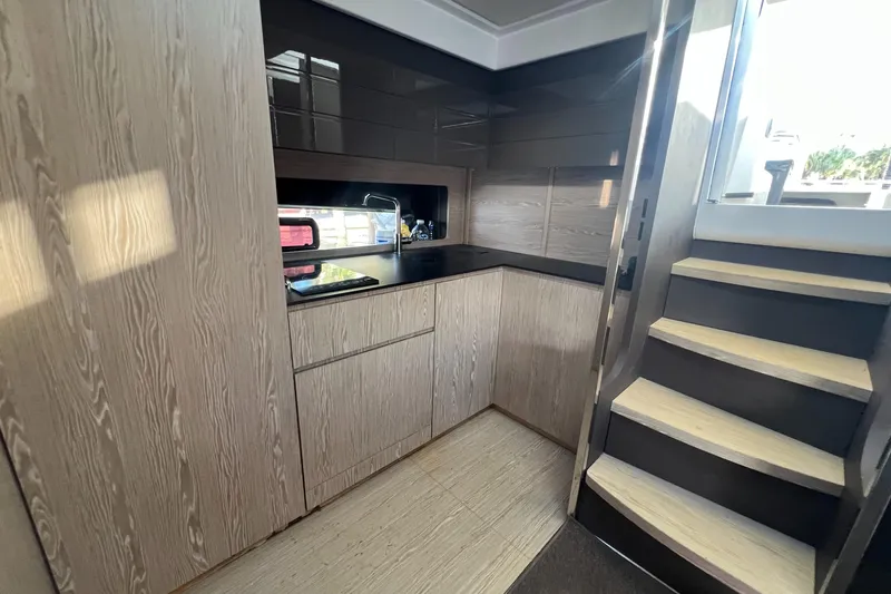  Yacht Photos Pics Modern kitchen interior on 2018 Azimut Atlantis 43 yacht, featuring sleek cabinetry and stairs.