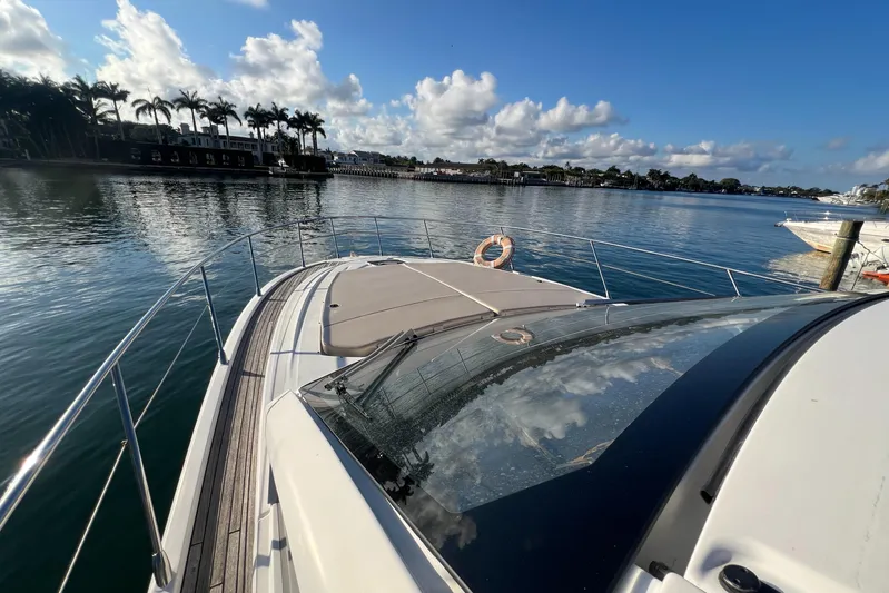  Yacht Photos Pics Azimut Atlantis 43 yacht, 2018 model, cruising on a serene waterway under a clear sky.
