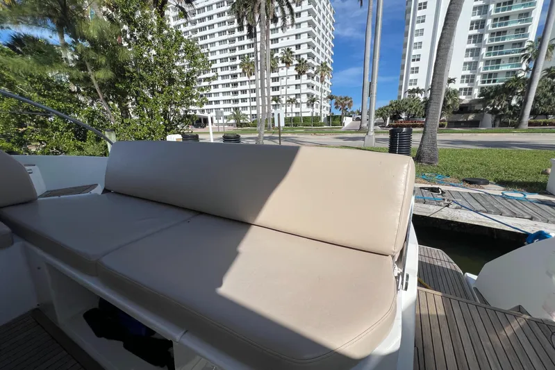  Yacht Photos Pics Azimut Atlantis 43 yacht seating area, 2018 model, with urban backdrop and palm trees.