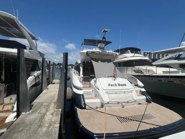  Yacht Photos Pics Sunseeker Predator 74 yacht docked at marina, clear sky, 2000 model.
