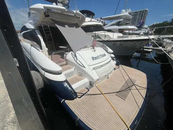  Yacht Photos Pics Sunseeker Predator 74 yacht, 2000 model, docked at marina with open sunshade.