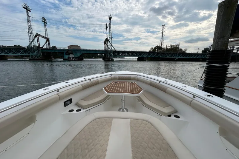  Yacht Photos Pics 2017 Boston Whaler 370 Outrage boat interior with bridge view and cloudy sky.