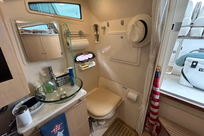  Yacht Photos Pics 2017 Boston Whaler 370 Outrage bathroom with modern amenities and nautical decor.