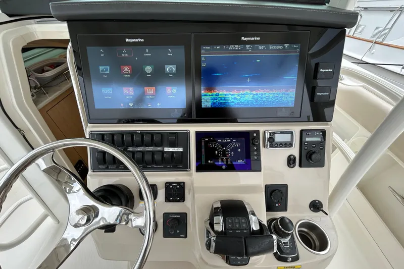  Yacht Photos Pics Control panel of a 2017 Boston Whaler 370 Outrage with Raymarine displays and steering wheel.