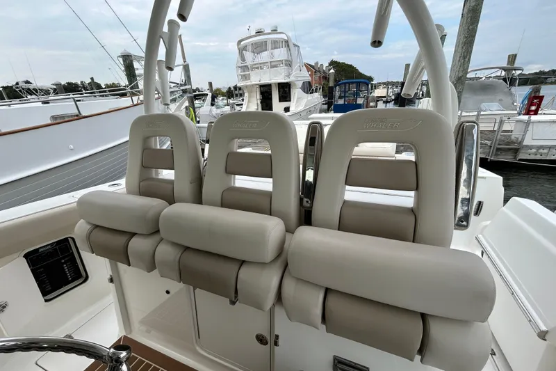  Yacht Photos Pics 2017 Boston Whaler 370 Outrage boat seats at marina, showcasing luxury design.