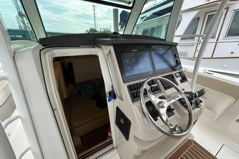  Yacht Photos Pics 2017 Boston Whaler 370 Outrage helm with advanced navigation system and cabin entrance.
