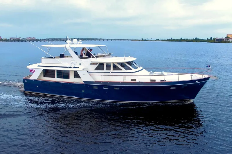 Brown Yacht Photos Pics 1989 Tollycraft 61 Pilothouse Motor Yacht cruising on calm waters.