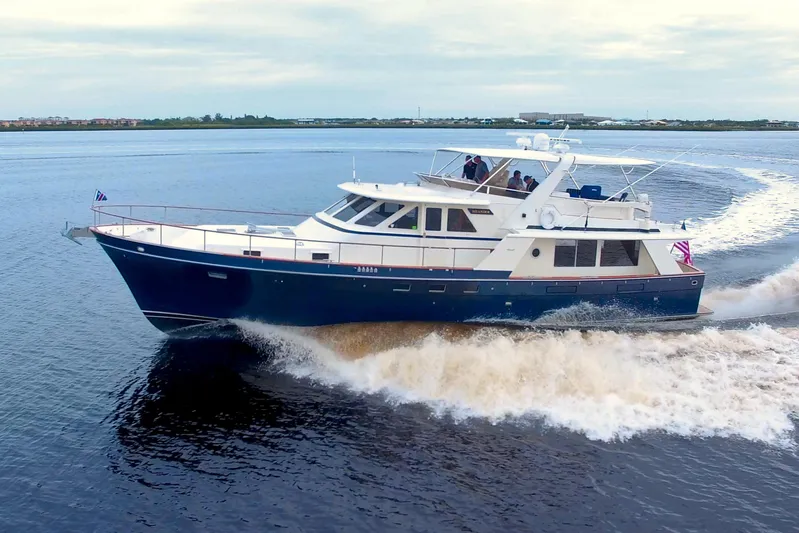Brown Yacht Photos Pics 1989 Tollycraft 61 Pilothouse Motor Yacht cruising on open water.