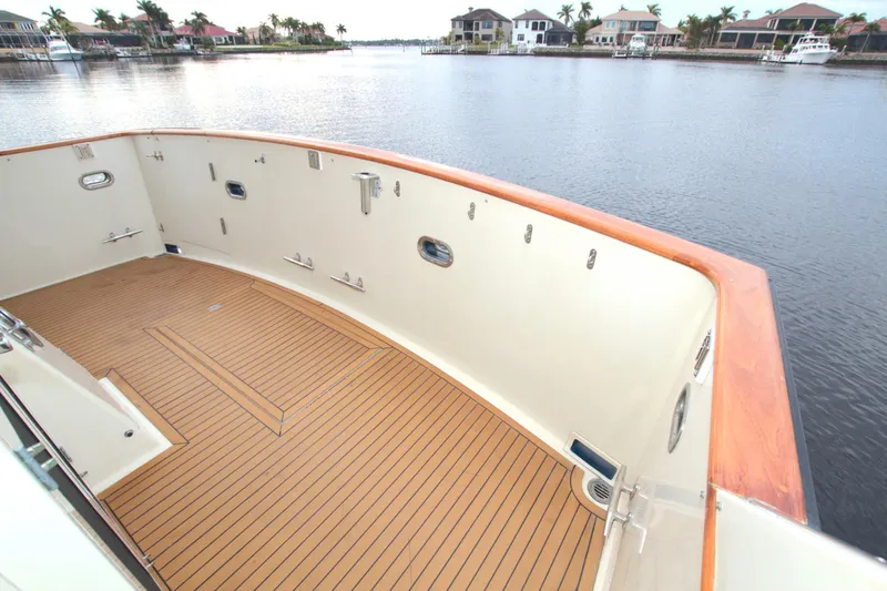 Brown Yacht Photos Pics 1989 Tollycraft 61 Pilothouse Motor Yacht deck overlooking serene waterfront homes.