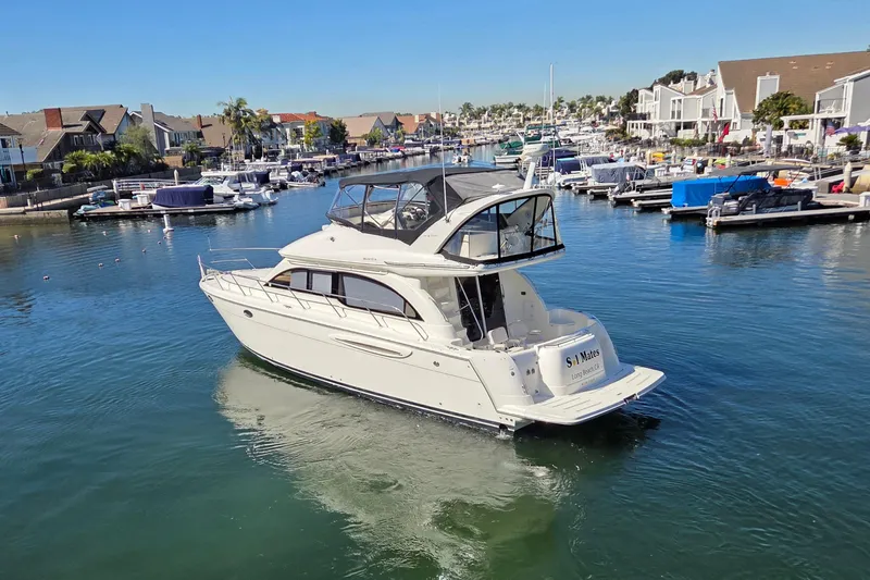 Soul Mates Yacht Photos Pics 2005 Meridian 411 Sedan yacht cruising in a marina with waterfront homes.
