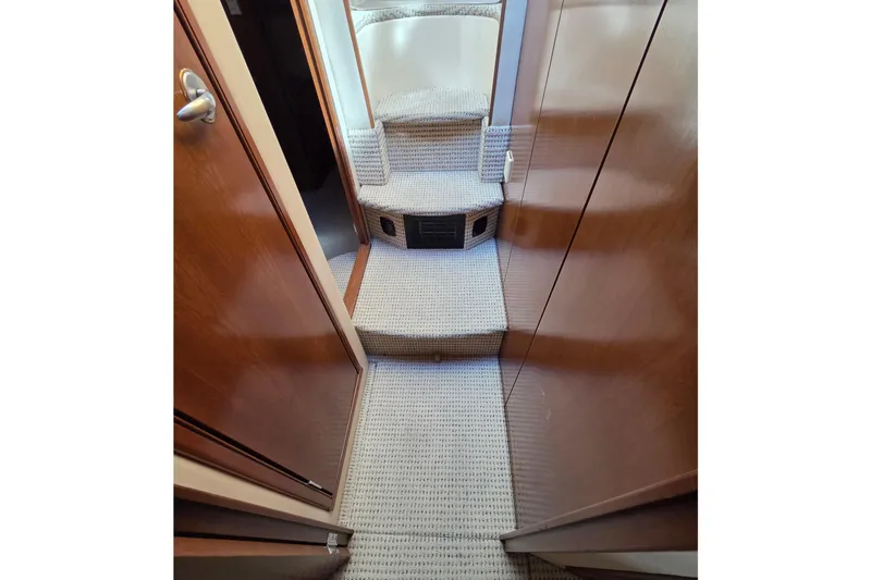 Soul Mates Yacht Photos Pics Interior of 2005 Meridian 411 Sedan yacht with carpeted stairs and wooden paneling.