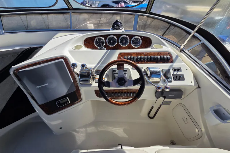 Soul Mates Yacht Photos Pics 2005 Meridian 411 Sedan helm with steering wheel, gauges, and control panel.