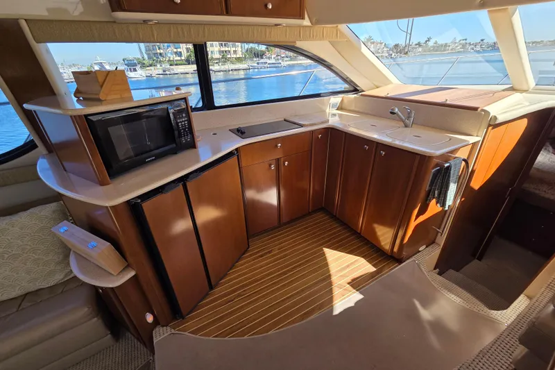 Soul Mates Yacht Photos Pics Luxurious kitchen interior of 2005 Meridian 411 Sedan yacht with wood cabinetry and appliances.