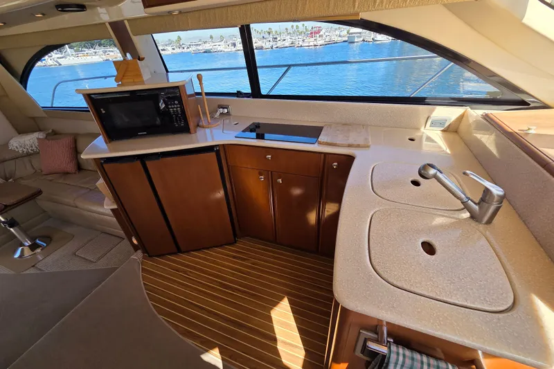 Soul Mates Yacht Photos Pics Luxurious 2005 Meridian 411 Sedan yacht interior with kitchen and scenic marina view.
