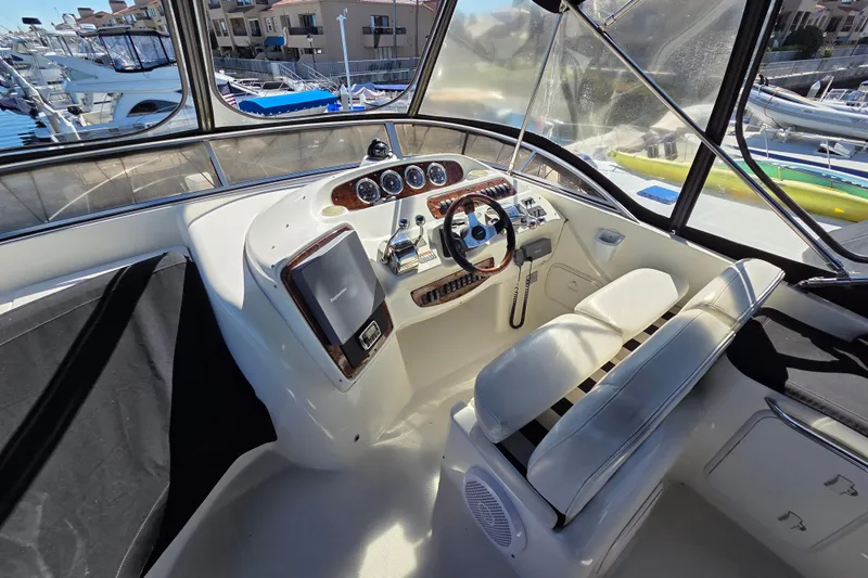 Soul Mates Yacht Photos Pics Interior of a 2005 Meridian 411 Sedan yacht with steering wheel and control panel.