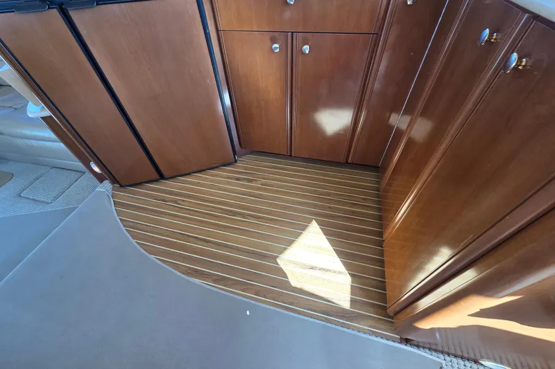 Soul Mates Yacht Photos Pics 2005 Meridian 411 Sedan interior with wooden cabinets and striped flooring.