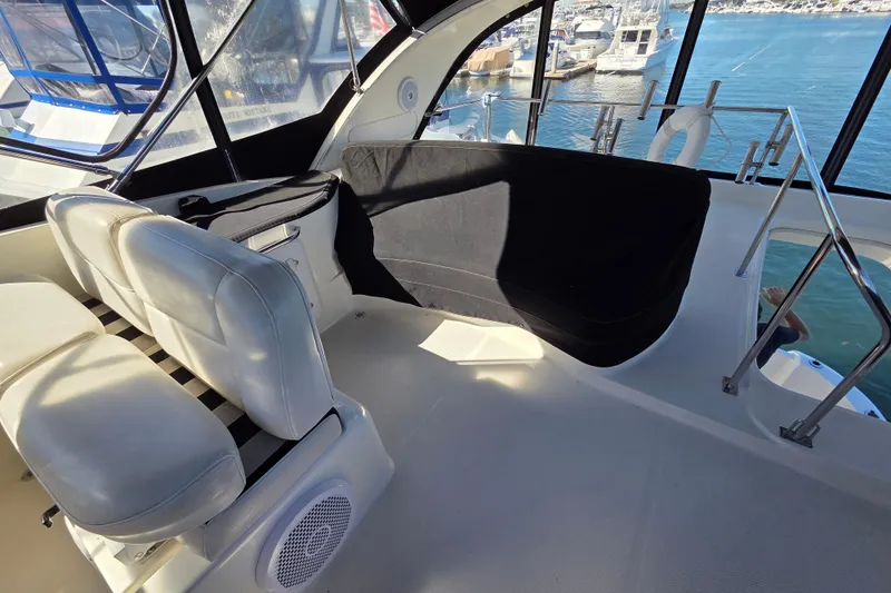 Soul Mates Yacht Photos Pics Interior of 2005 Meridian 411 Sedan yacht with white seating and marina view.