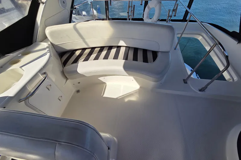 Soul Mates Yacht Photos Pics 2005 Meridian 411 Sedan interior with white seating and striped cushions.