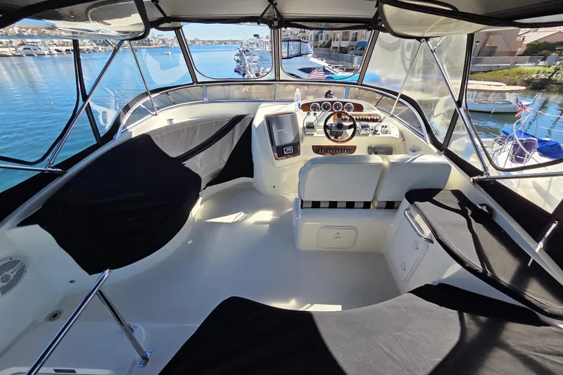 Soul Mates Yacht Photos Pics 2005 Meridian 411 Sedan yacht cockpit with steering wheel and marina view.