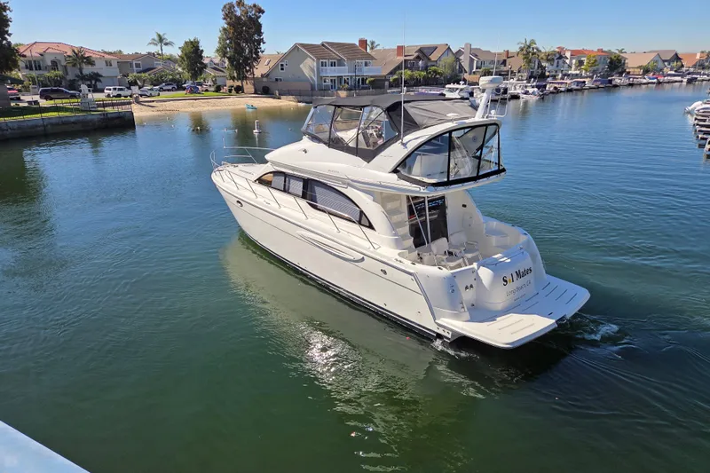 Soul Mates Yacht Photos Pics 2005 Meridian 411 Sedan yacht cruising in a serene marina setting.