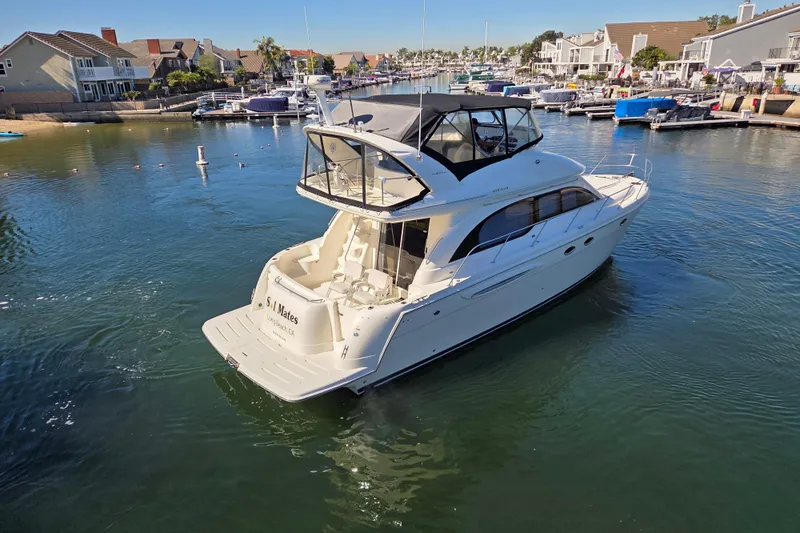 Soul Mates Yacht Photos Pics 2005 Meridian 411 Sedan yacht cruising in a scenic marina setting.